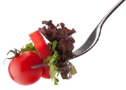 Fresh salad and cherry tomato on fork isolated on white backgrou